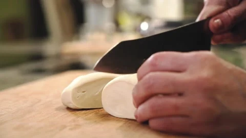 The chef is slicing and rolling out the dough. Stock Footage 146877977