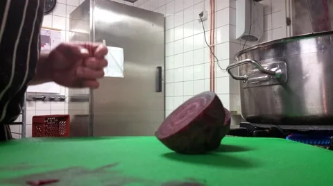 Chef is slicing beetroots, at a restaurant kitchen Stock Footage 59618132