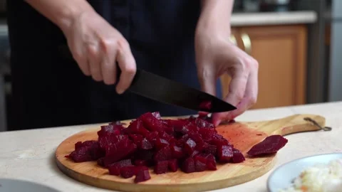 Chef slicing boiled beetroot on a cutting board Stock Footage 328593345