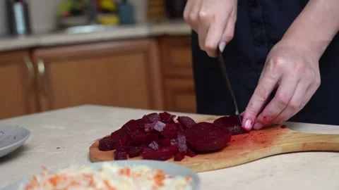 Chef slicing boiled beetroot on a cutting board Stock Footage 328593635