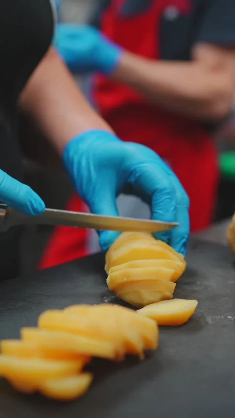 Chef Slicing Boiled Potatoes in Kitchen Stock Footage 346177753