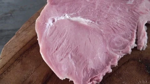 Chef slicing cooked ham on cutting board in kitchen 스톡 동영상 342819074