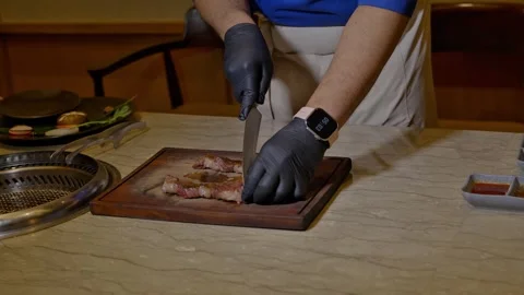 Chef slicing cooked meat, perfect for food videos 스톡 동영상 311012677
