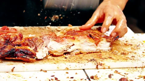 Chef Slicing Crispy Peruvian Chicharron Pork on Cutting Board Stock Footage 338341357