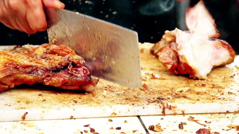Chef Slicing Crispy Peruvian Chicharron Pork on Cutting Board Stock Footage 338341361