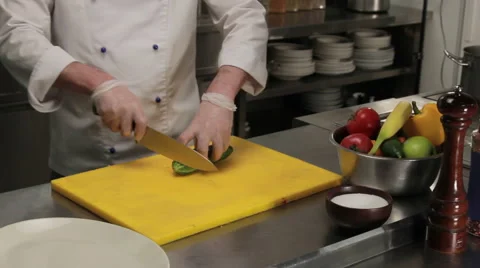 Chef slicing a cucumber finely, medium shot Vidéo 66064408