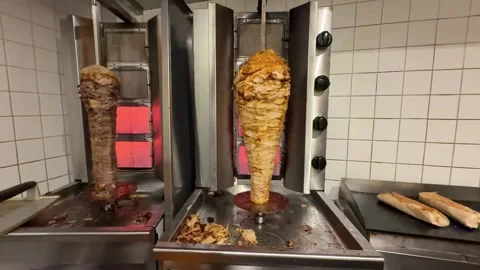 Chef slicing doner kebab meat at restaurant 스톡 동영상 336232919