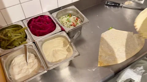 Chef slicing doner kebab meat at restaurant 動画素材 336232920
