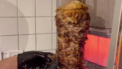 Chef slicing doner kebab meat at restaurant Stock Footage 336232922