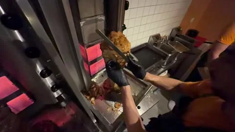 Chef slicing doner kebab meat at restaurant 스톡 동영상 336232928