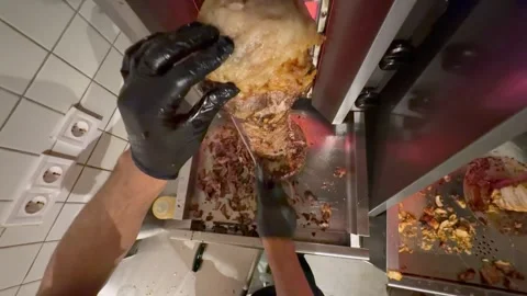 Chef slicing doner kebab meat at restaurant Видео 336232932
