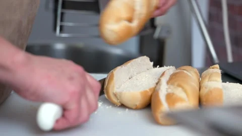 Chef Slicing Fresh Bread Loaf on Cutting Board Stock Footage 321367111