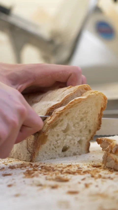 Chef Slicing Fresh Bread Into Pieces for Bruschetta, Restaurant Kitchen Stock Footage 336793730