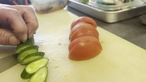 Chef Slicing A Fresh Cucumber On A Cutting Board In A Japanese Kitchen Stock-Footage 338320191