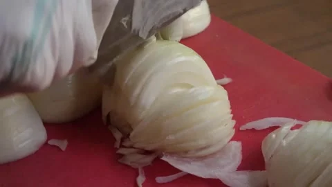 Chef Slicing Fresh Onion on Red Cutting Board with Cleaver Knife Video stock 343587925