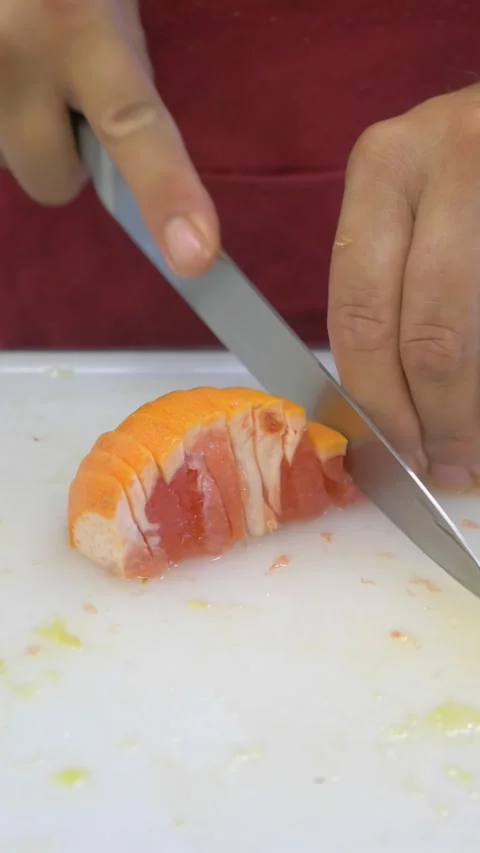 Chef slicing fresh orange for cocktail garnish preparation Stock Footage 340152012