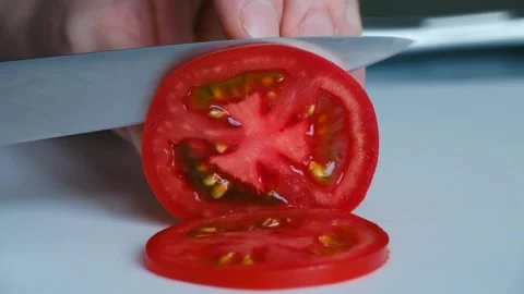 Chef slicing fresh red tomato with knife Stock-Footage 337891484