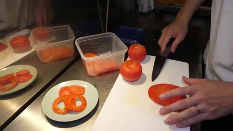 Chef Slicing Fresh Red Tomatoes on Cutting Board in Commercial Kitchen Stock-Footage 347689375