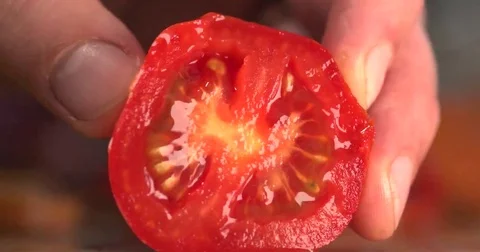 Chef slicing a fresh ripe red tomato ready for cooking Stock Footage 69273136