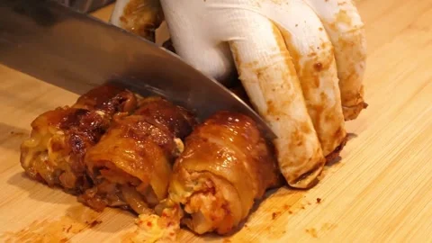 Chef Slicing Freshly Grilled Pork Belly Kimchi Roll on Wooden Board Stock Footage 343588091