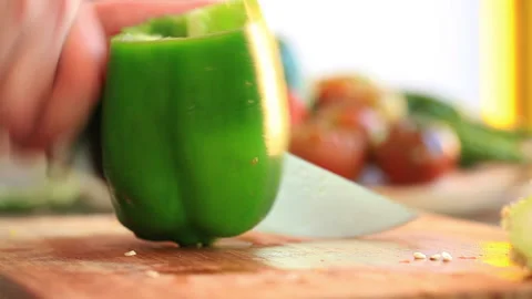 Chef slicing green pepper with a big knife Stock Footage 232929870