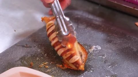 Chef Slicing Grilled Squid on Flat Top Griddle Stock Footage 344218191