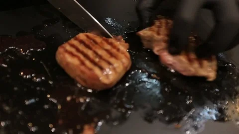Chef slicing of grilled steak on a cutting board Stock Footage 82606231