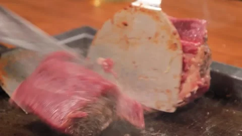 Chef Slicing High-Grade Marbled Wagyu Beef on Teppanyaki Grill Stock Footage 333521029