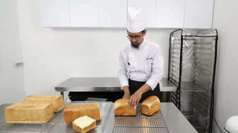 Chef Slicing Japanese Loaf Bread in a Professional Kitchen Stock Footage 296045554