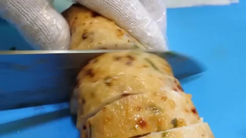 Chef Slicing Korean Vegetable Fish Cake Eomuk on Blue Cutting Board Close Up Stock Footage 337374713