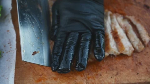 Chef Slicing a Large Roasted Pork Cut into Strips During Food Preparation Stock Footage 341155434