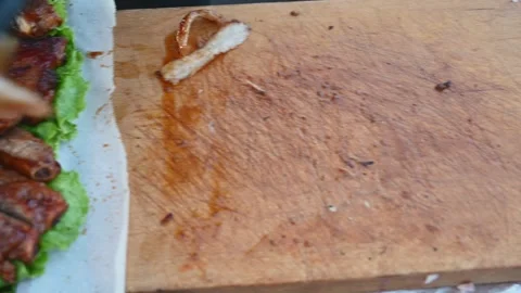 Chef Slicing a Large Roasted Pork Cut into Strips During Food Preparation Stock Footage 341155472