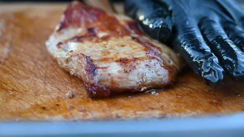 Chef Slicing a Large Roasted Pork Cut into Strips During Food Preparation Stock Footage 341155476