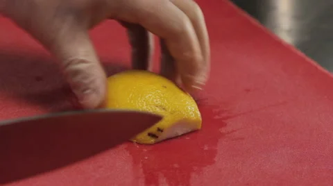 Chef slicing lemon finely, close up Stock Footage 66061568
