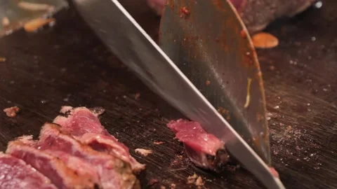 Chef Slicing Medium-Rare Wagyu Steak on Teppanyaki Grill Stock Footage 333600196