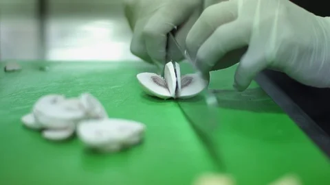 Chef slicing mushrooms in kitchen Stock Footage 98240921
