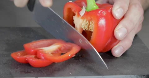 Chef slicing paprika on plate Stockbeeldmateriaal 243765897