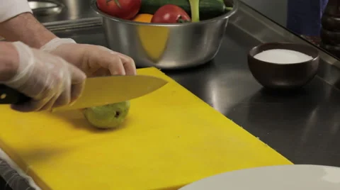 Chef slicing a peer, close up 库存影片 66058160