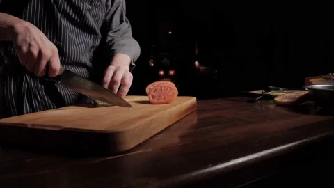Chef slicing pickled cucumber with a very sharp knife on a wooden cutting board Stock Footage 135881009