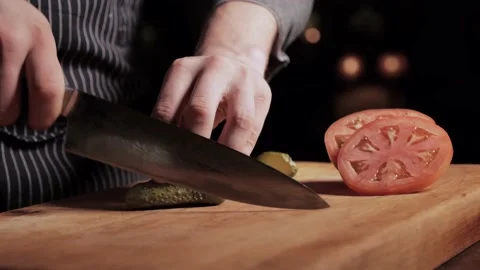Chef slicing pickled cucumber with a very sharp knife. Close-up zoom out Video stock 135881293