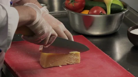 Chef slicing a piece of cheese 库存影片 66075535