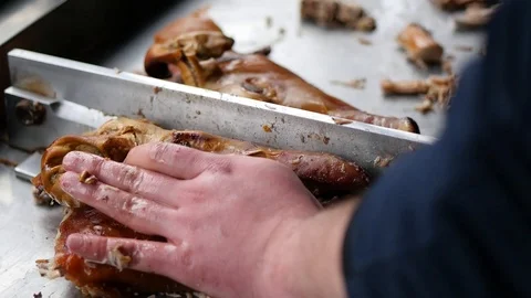 Chef slicing pig head in two pieces Stock Footage 88828039
