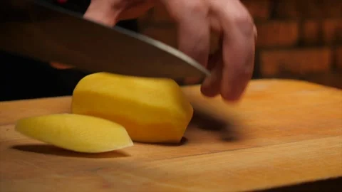 Chef slicing potato Stock Footage 148527325