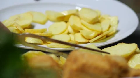 Chef Slicing Potatoes for a Traditional Dish Stock Footage 341679306