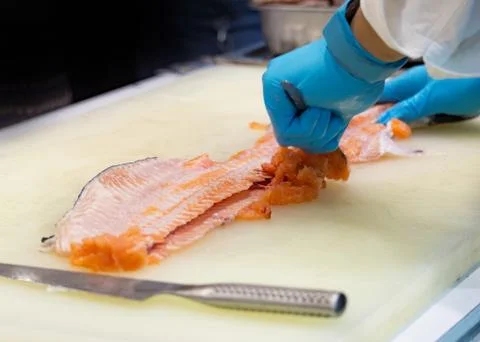 Chef slicing raw fresh salmon, Chef preparing a fresh salmon on a cutting boa Stock Photos
