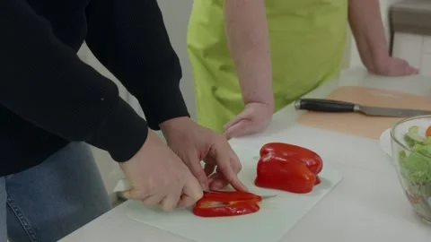 Chef slicing red bell pepper on cutting board Video stock 312659220