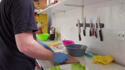 Chef slicing red cherry tomatoes in a restaurant kitchen Stock Footage 286310164