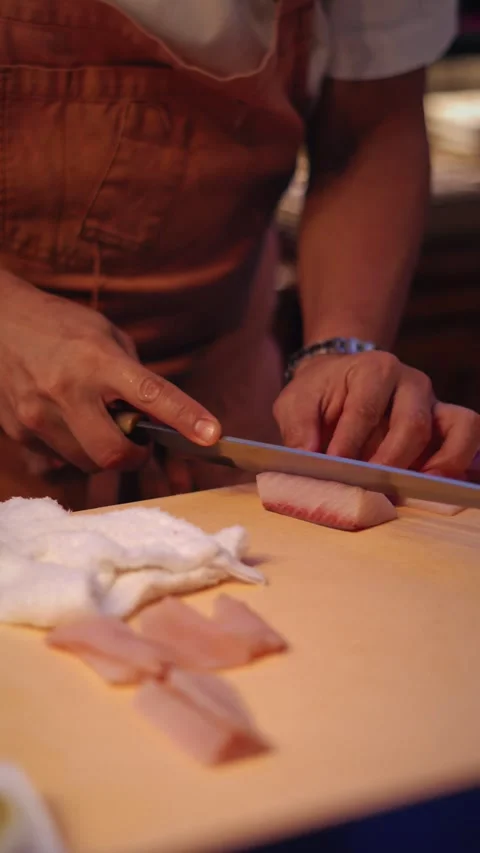 Chef slicing snapper sashimi in asian kitchen counter vertical 4K video Stock Footage 317408543