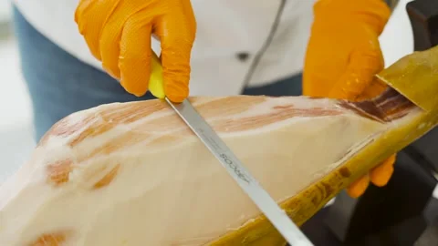Chef slicing Spanish jamon ham for guests at elegant reception Stock Footage 314458700