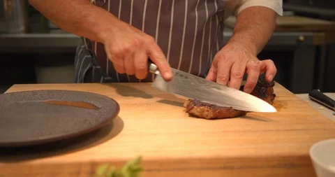 Chef Slicing Steak, Beef in Luxury Steak Restaurant Stock Footage 127526458